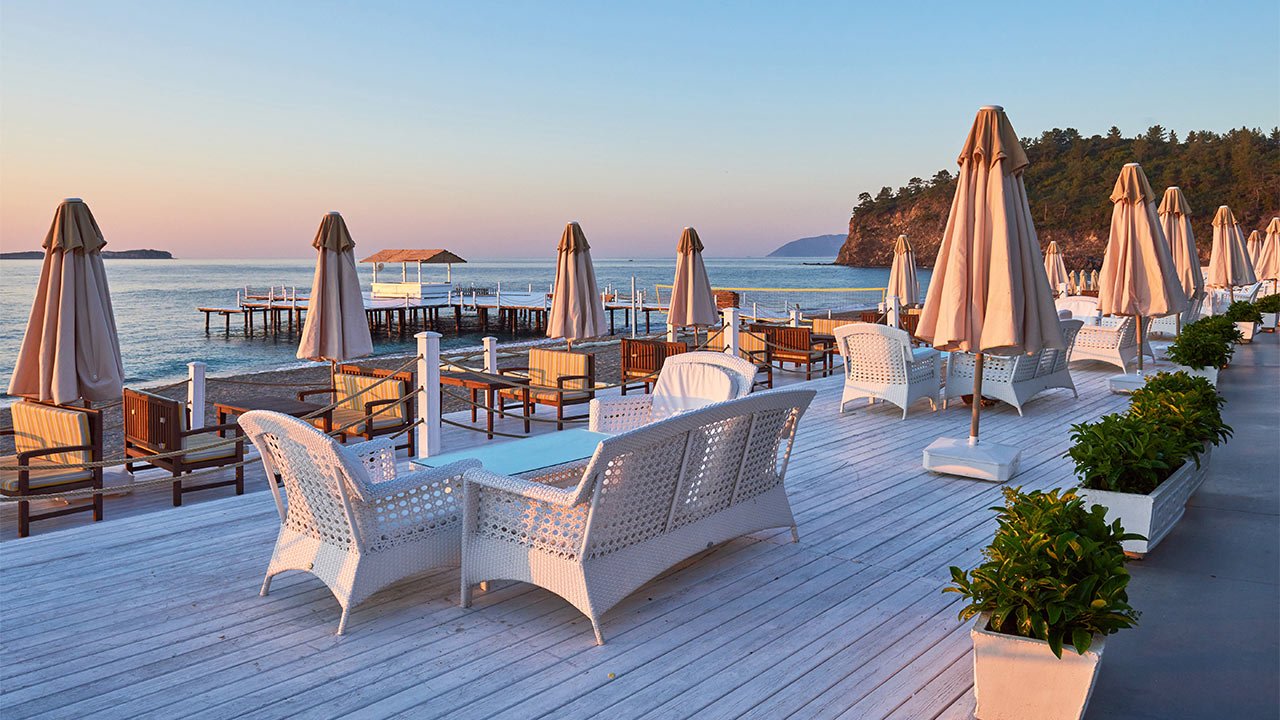 Seaside terrace with umbrellas at sunset