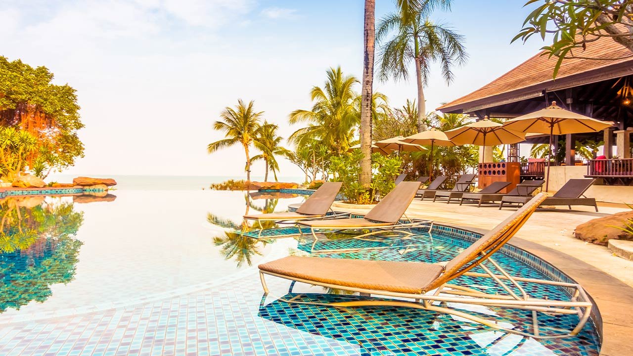 Infinity pool with lounge chairs overlooking the water